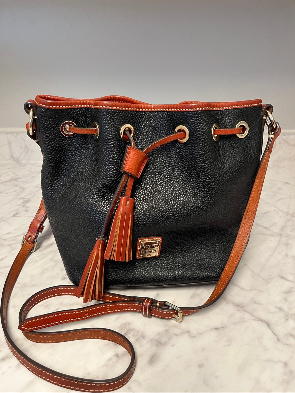Dooney & Bourke Black Pebbled Leather Drawstring Crossbody with Brown Trim